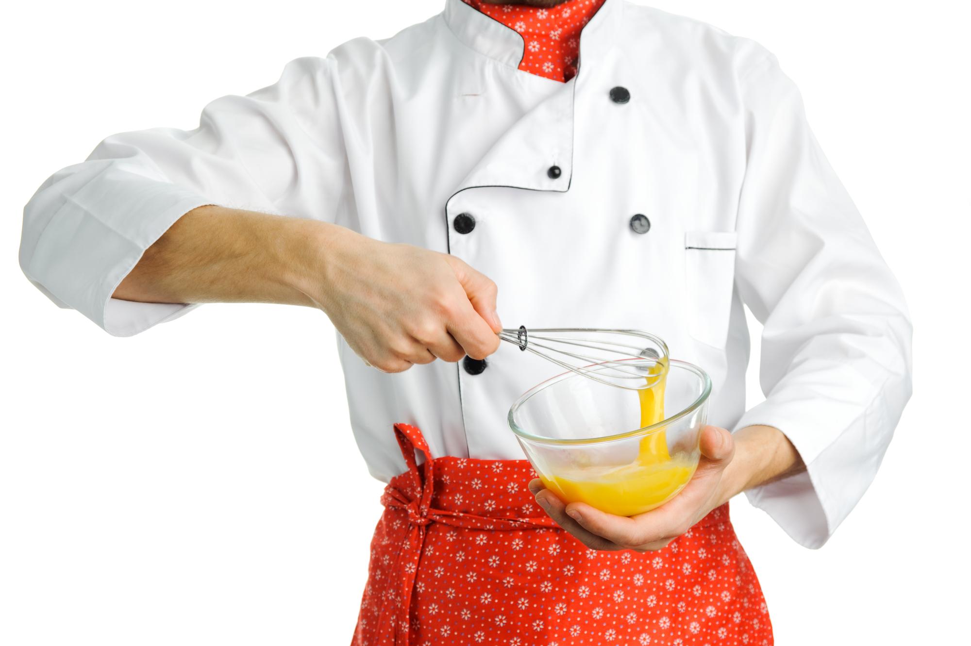 Chef demonstrating plating in a home kitchen